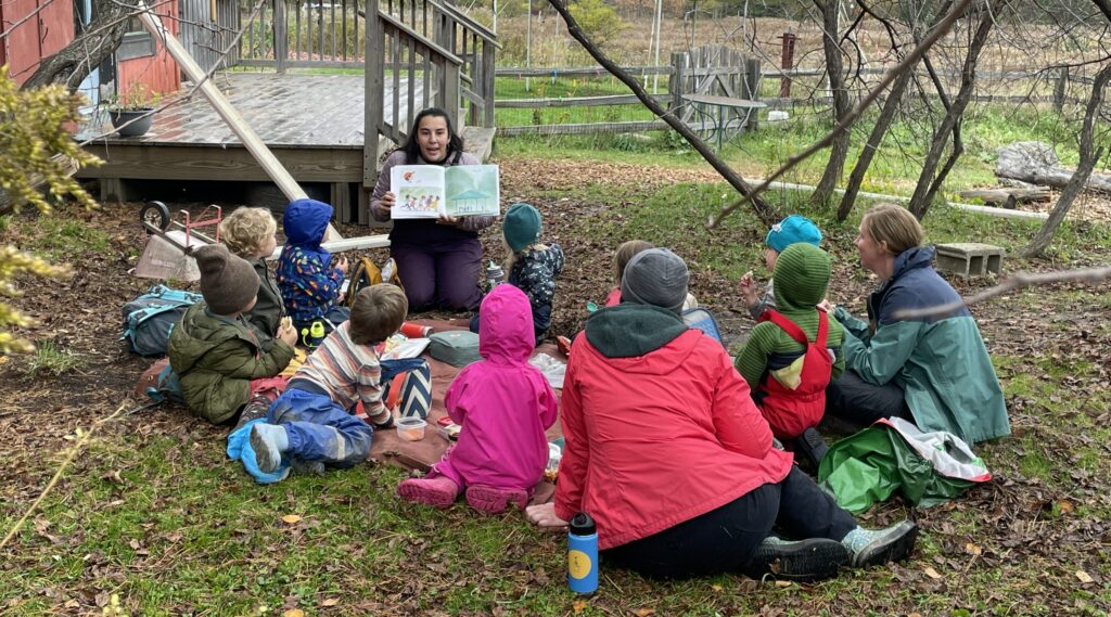 preschool teacher arianna reading to students