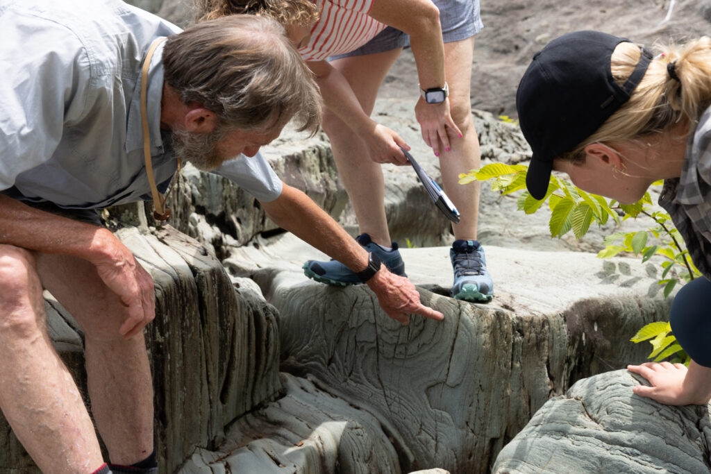 instructor pointing at rocks